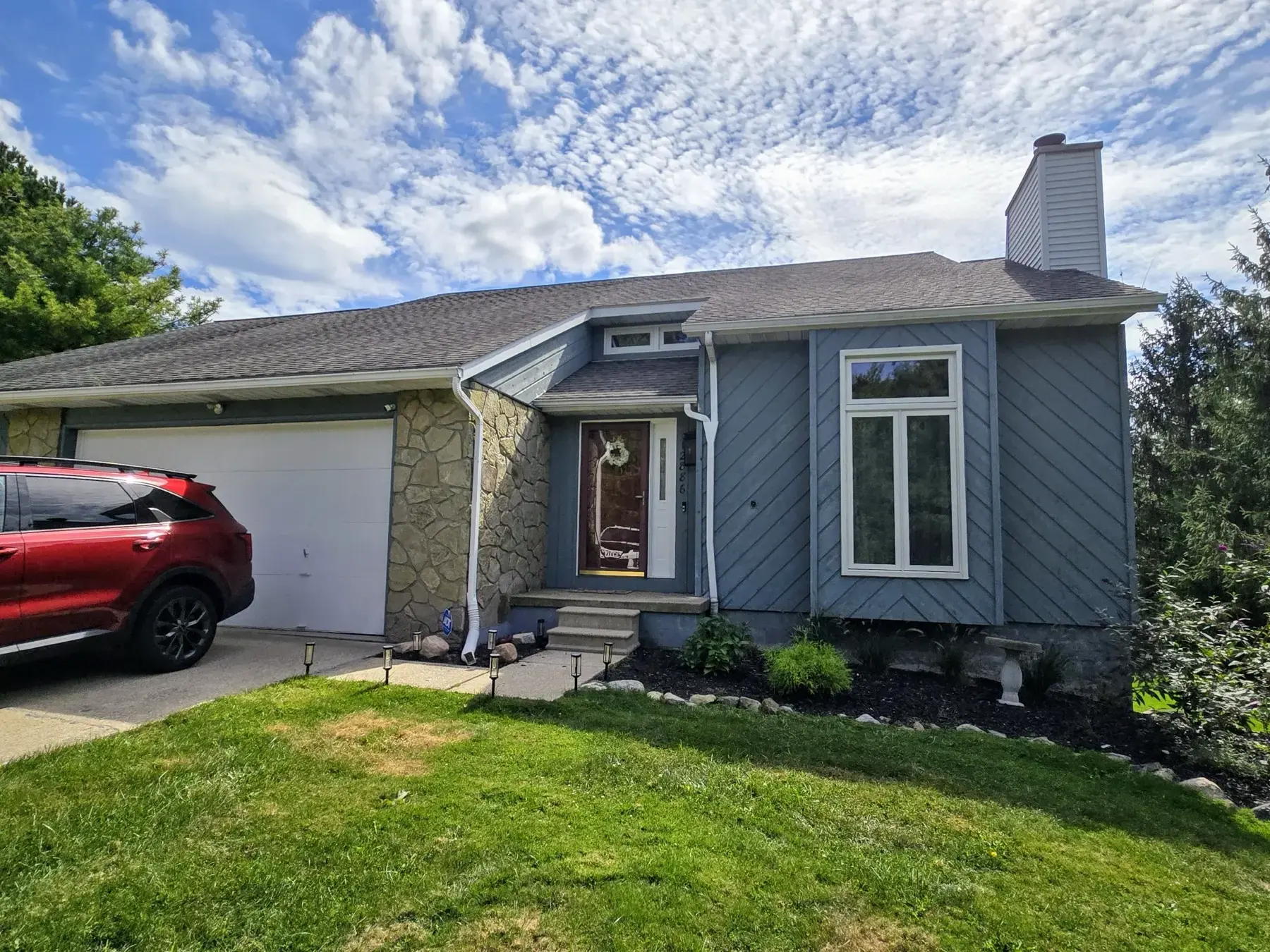 Before siding, stonework, garage doors, and gutter installation