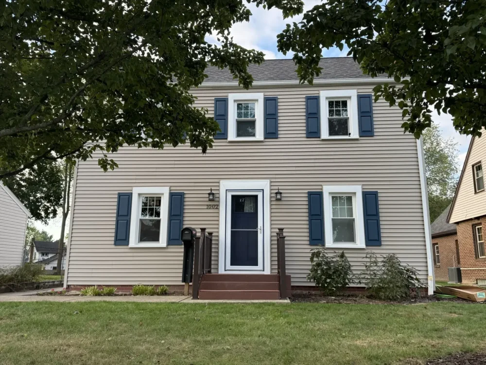 Siding, shutters, and new front door by Biltmore Exteriors in Canton
