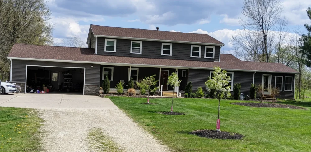 New siding, stonework, windows and gutters