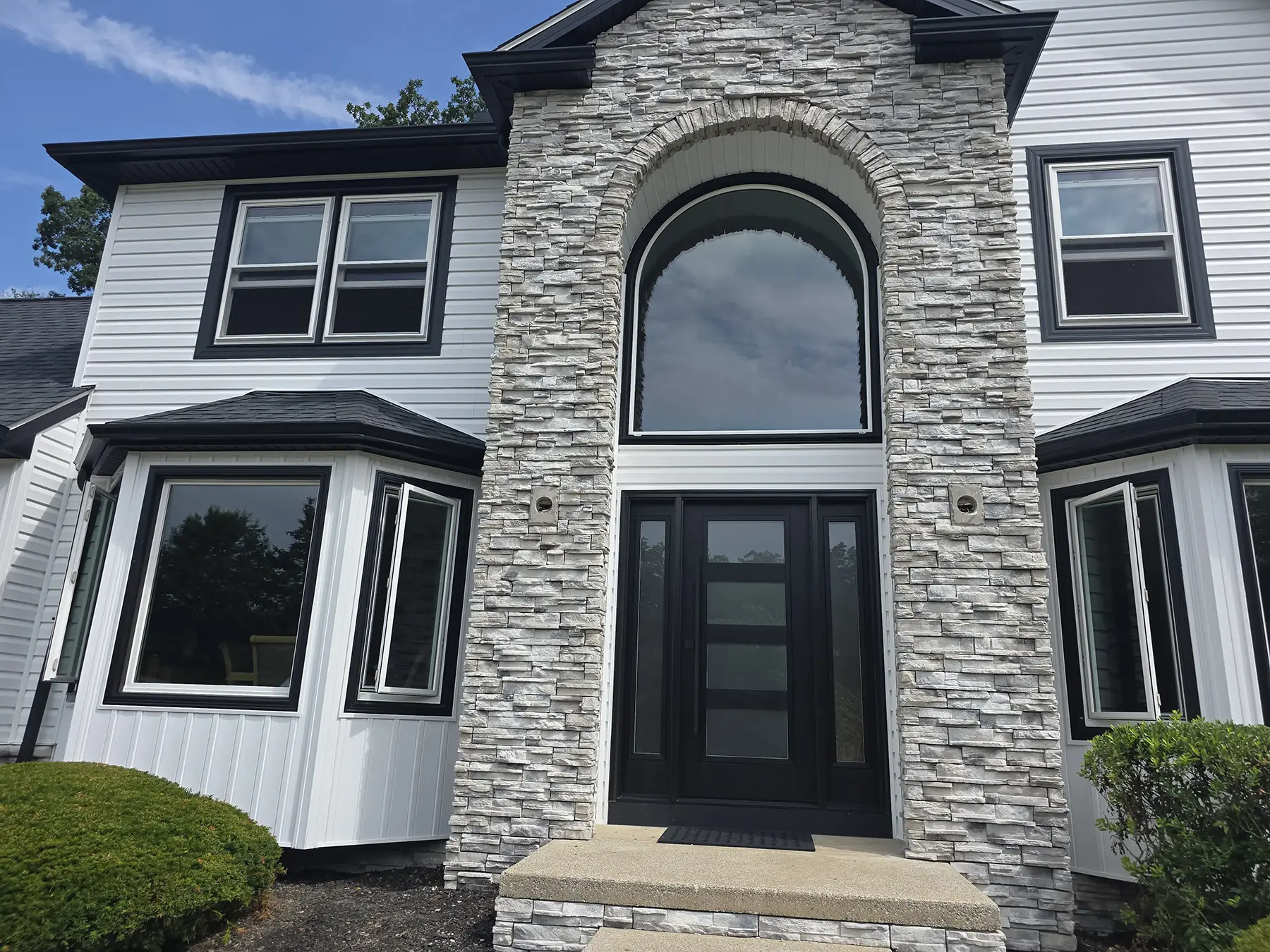 Siding, windows, stonework, soffit and gutters